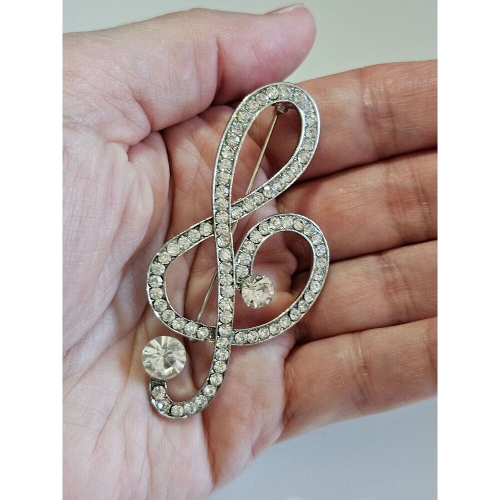 Silver tone treble clef brooch clear rhinestone